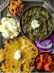 PUNJABI THALI:- SARSON KA SAAG + 3 MAKKI DI ROTI + SALAD + LASSI + BUTTER + GULAB JAMUN